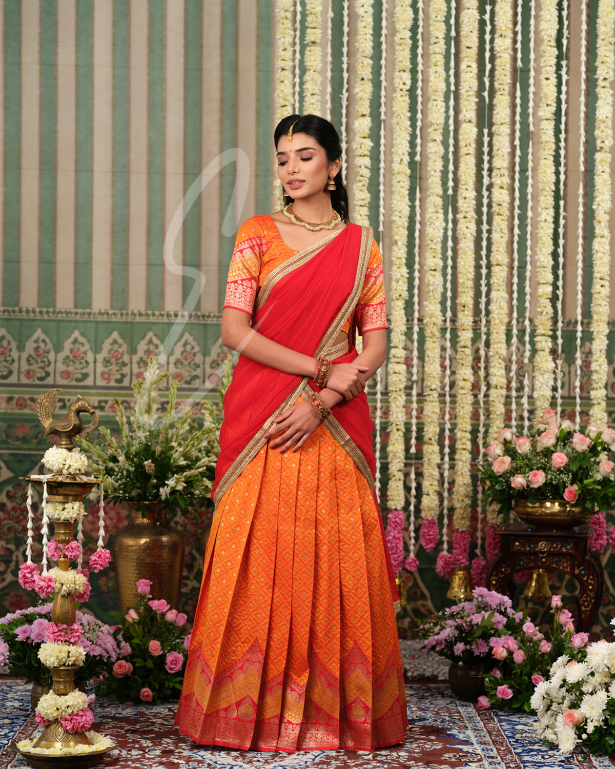 Vibrant orange Banarasi silk half saree with rich woven detailing