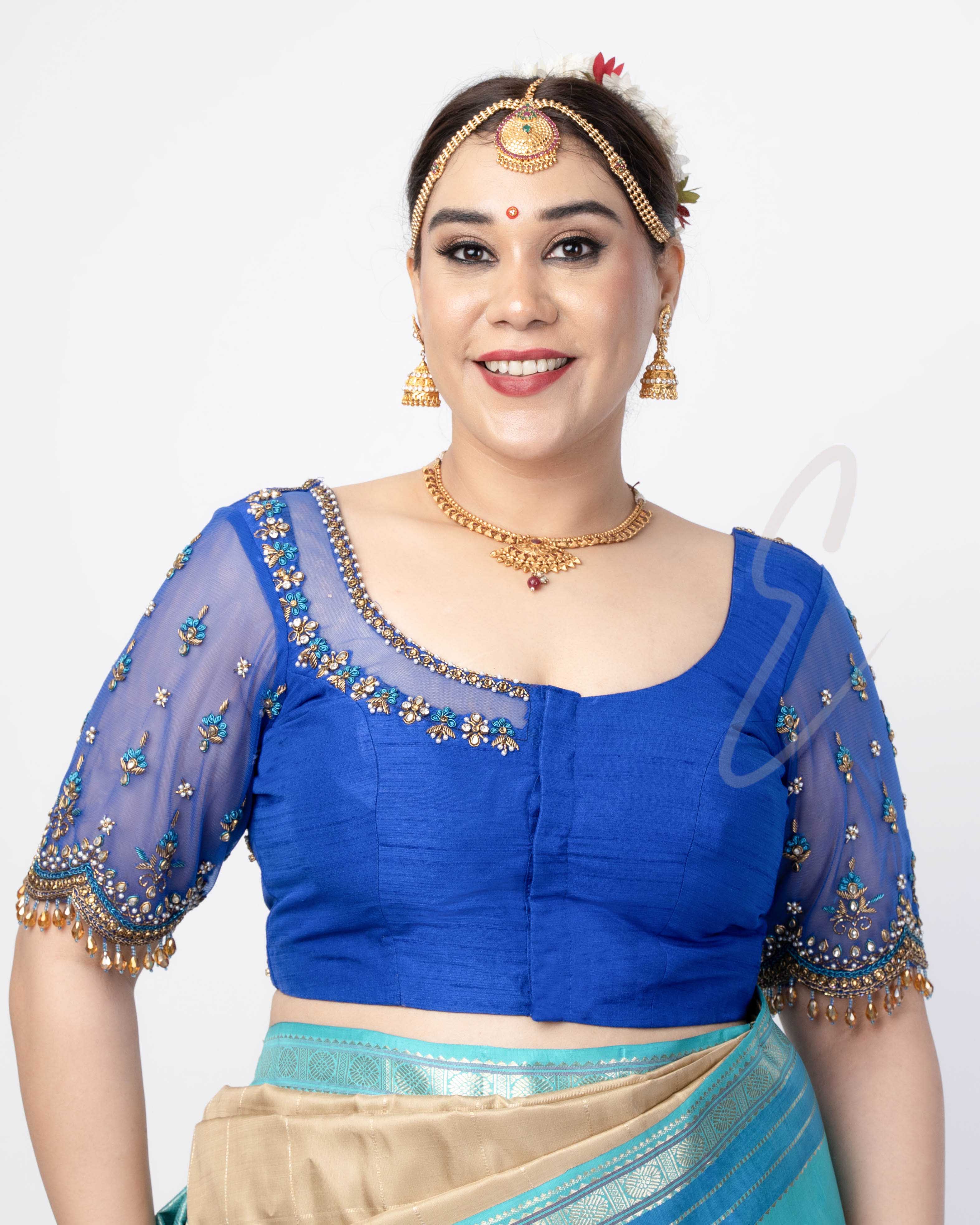 A blue raw silk with net blouse designed