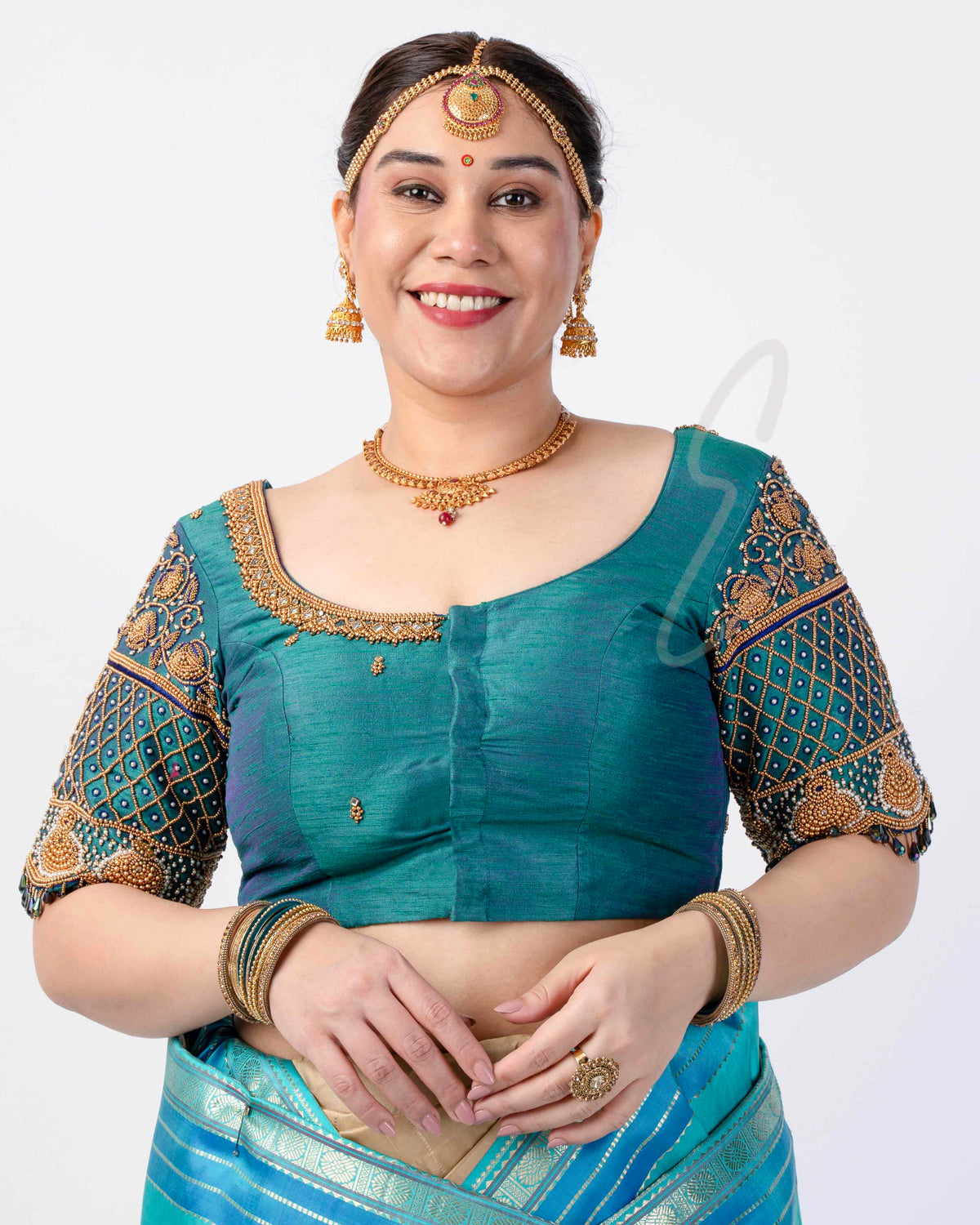A peacock green raw silk blouse