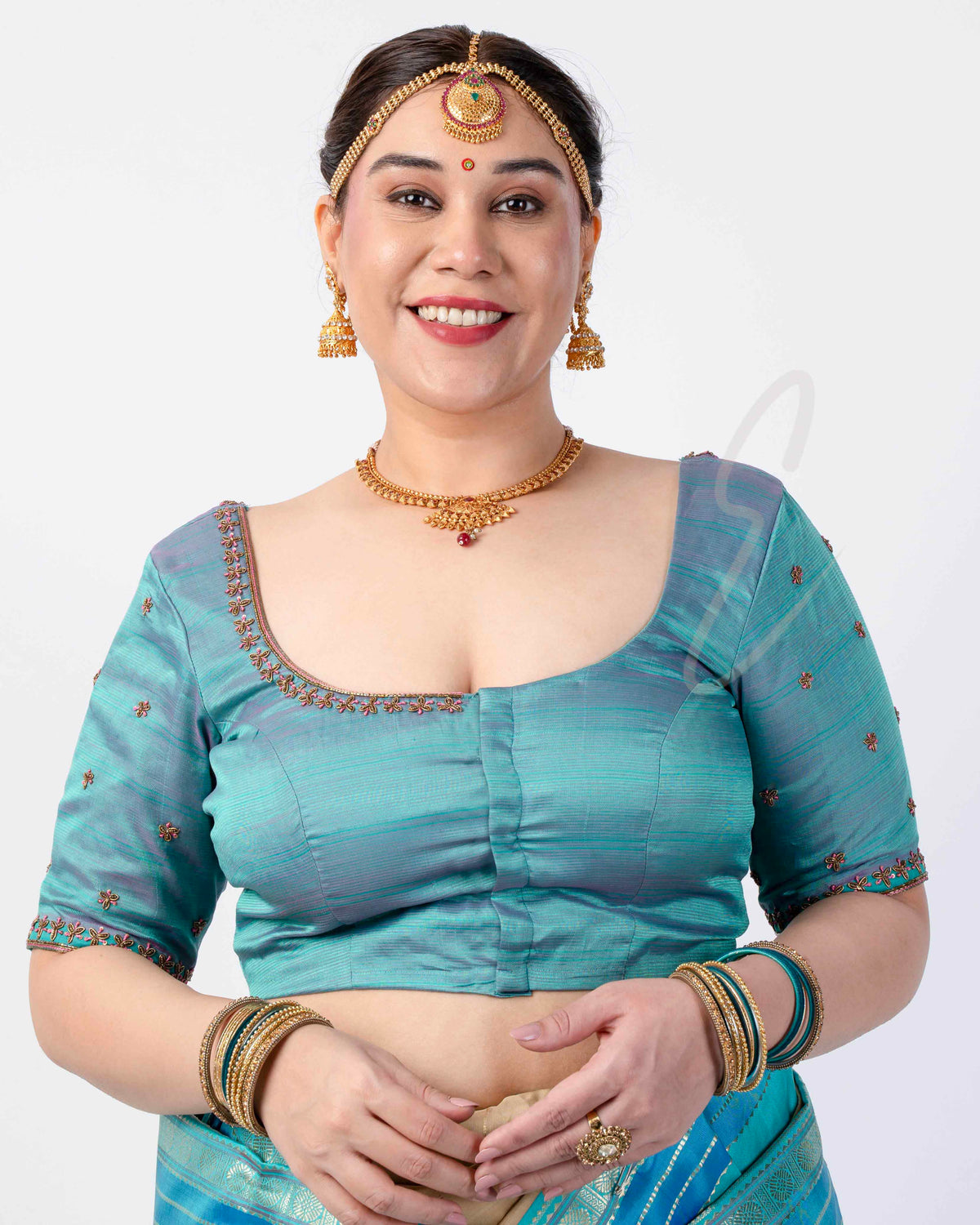 teal silk blouse designed in a princess-cut style