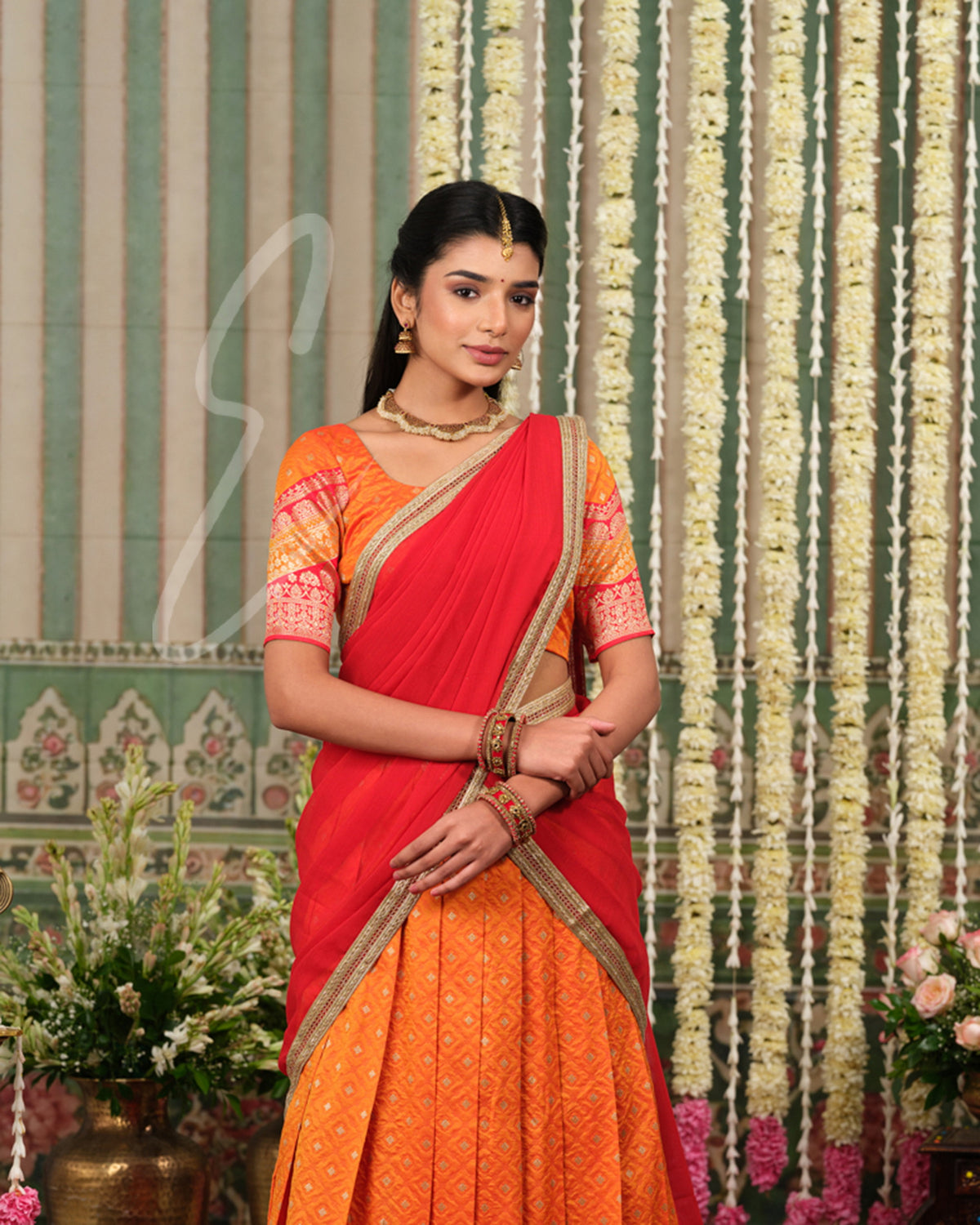 Vibrant orange Banarasi silk half saree with rich woven detailing