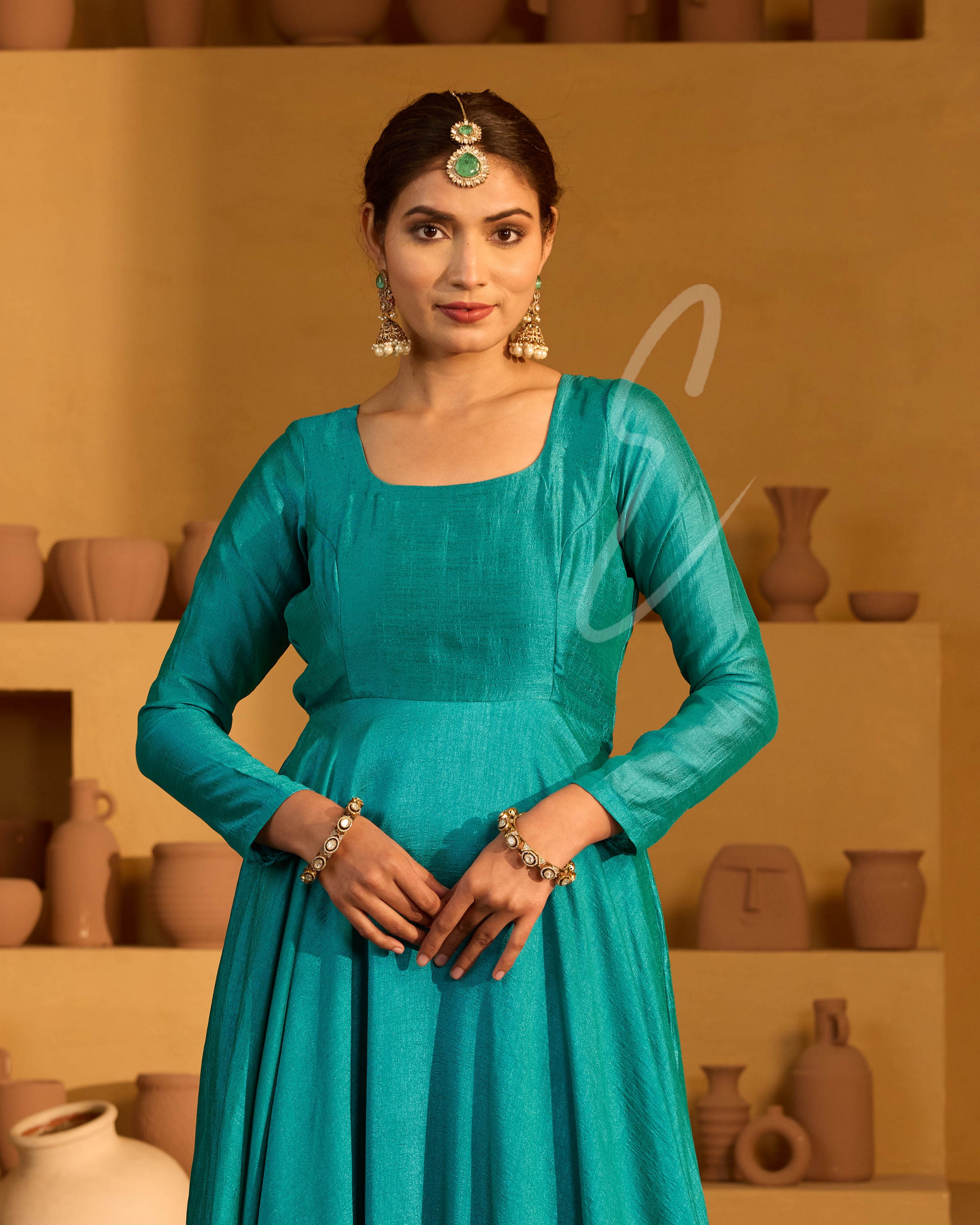 A peacock green flared gown