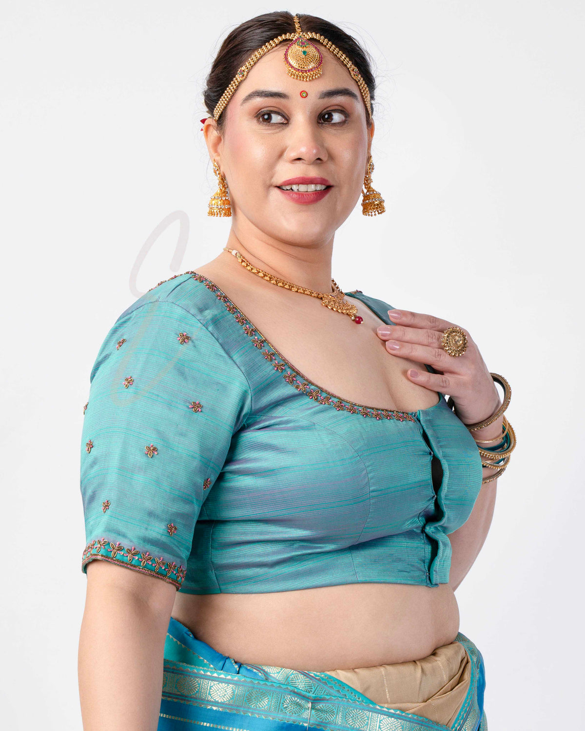 teal silk blouse designed in a princess-cut style