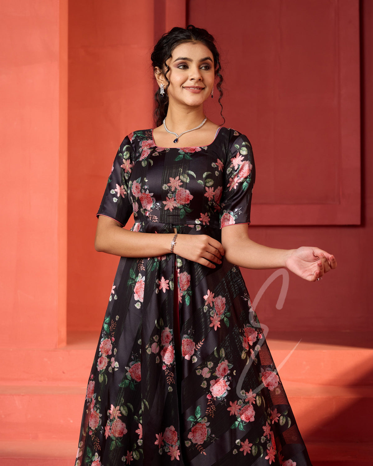 A flowy deep onion pink georgette plaza paired with a black printed georgette satin long coat