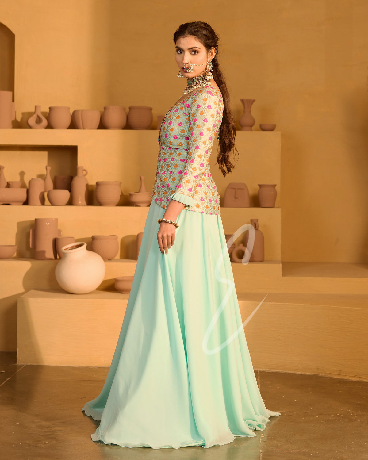 A graceful aqua blue outfit featuring a flowing georgette skirt