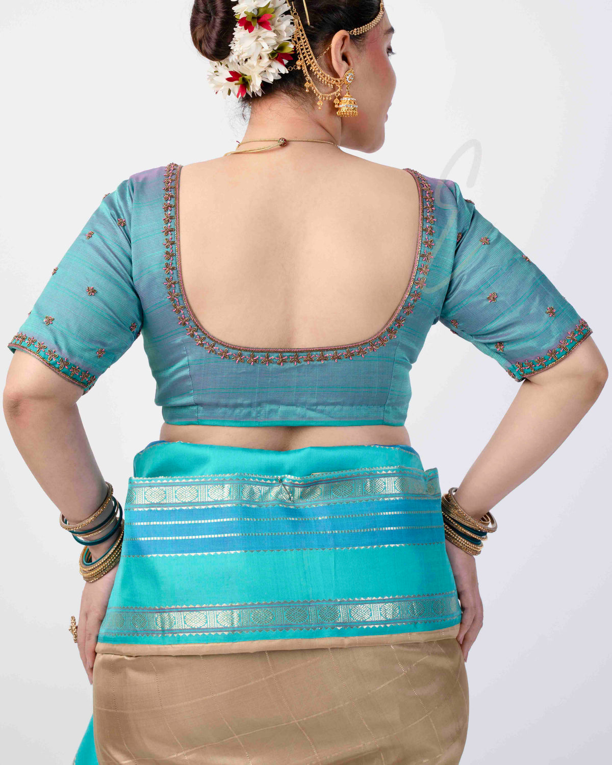 teal silk blouse designed in a princess-cut style