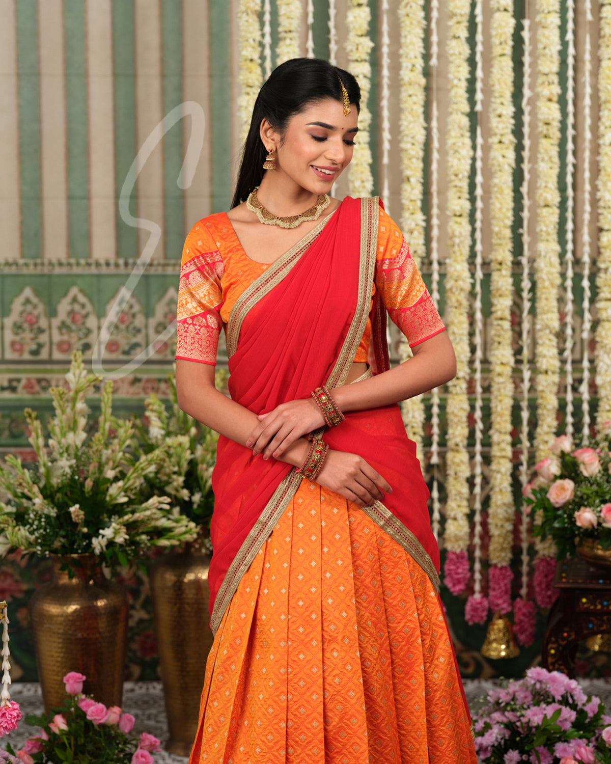 Vibrant orange Banarasi silk half saree with rich woven detailing