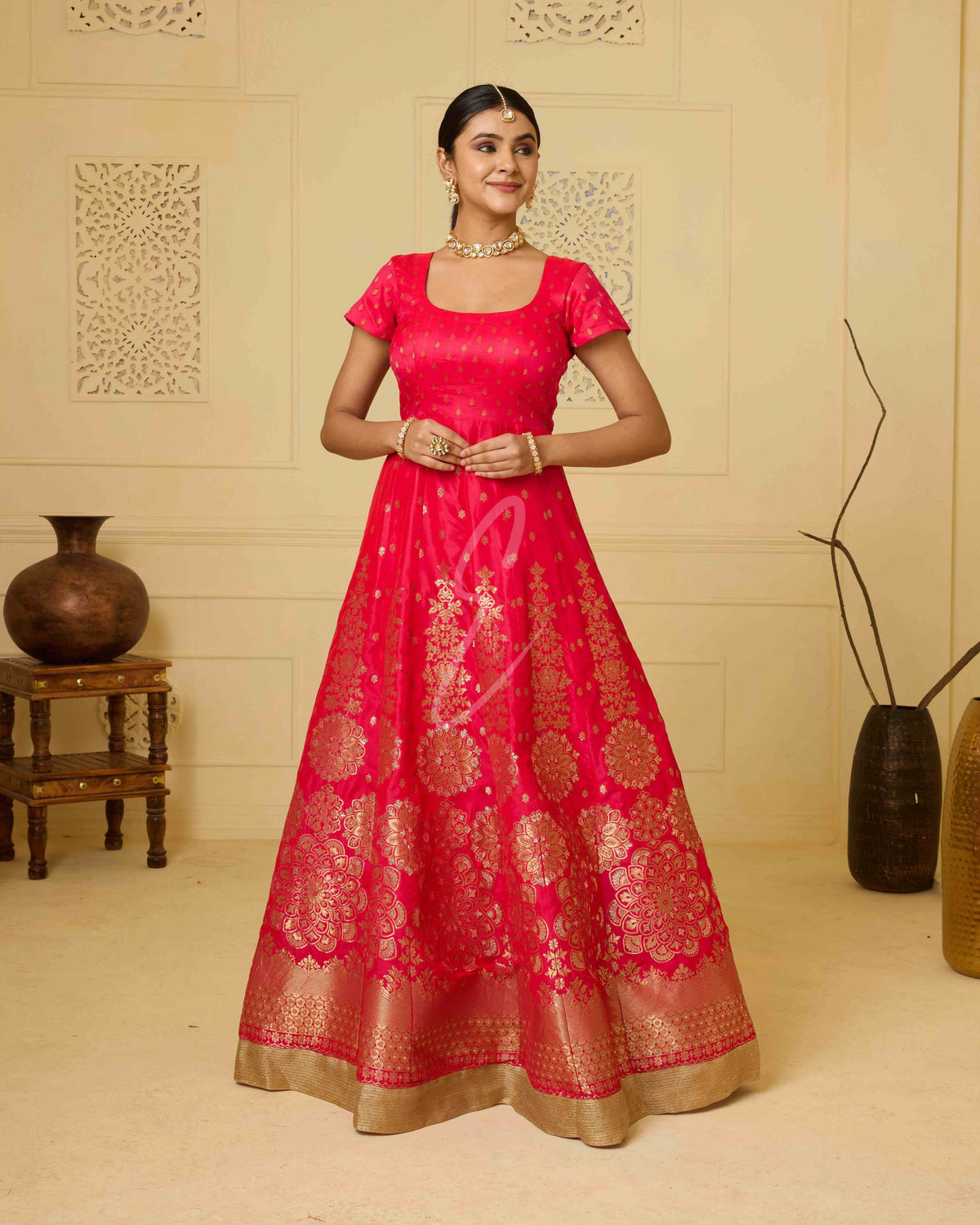 A deep pink Banarasi silk gown