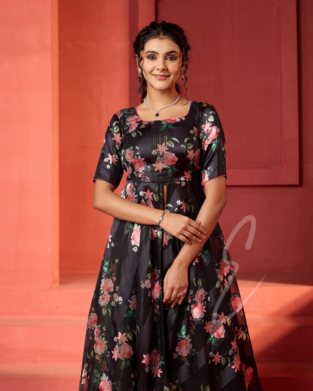 A flowy deep onion pink georgette plaza paired with a black printed georgette satin long coat