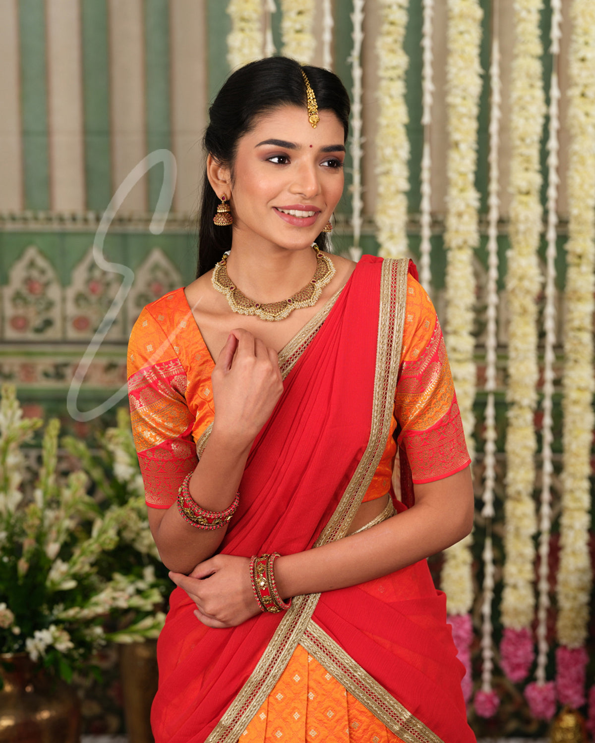 Vibrant orange Banarasi silk half saree with rich woven detailing