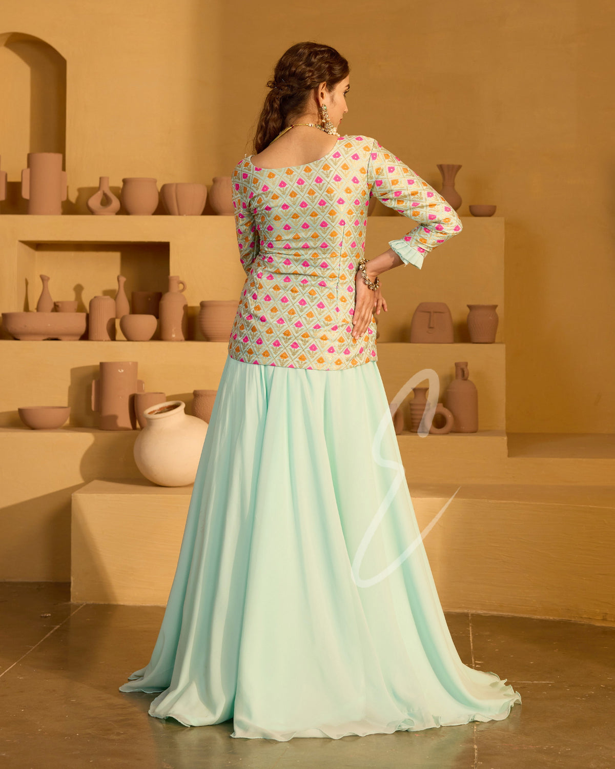 A graceful aqua blue outfit featuring a flowing georgette skirt