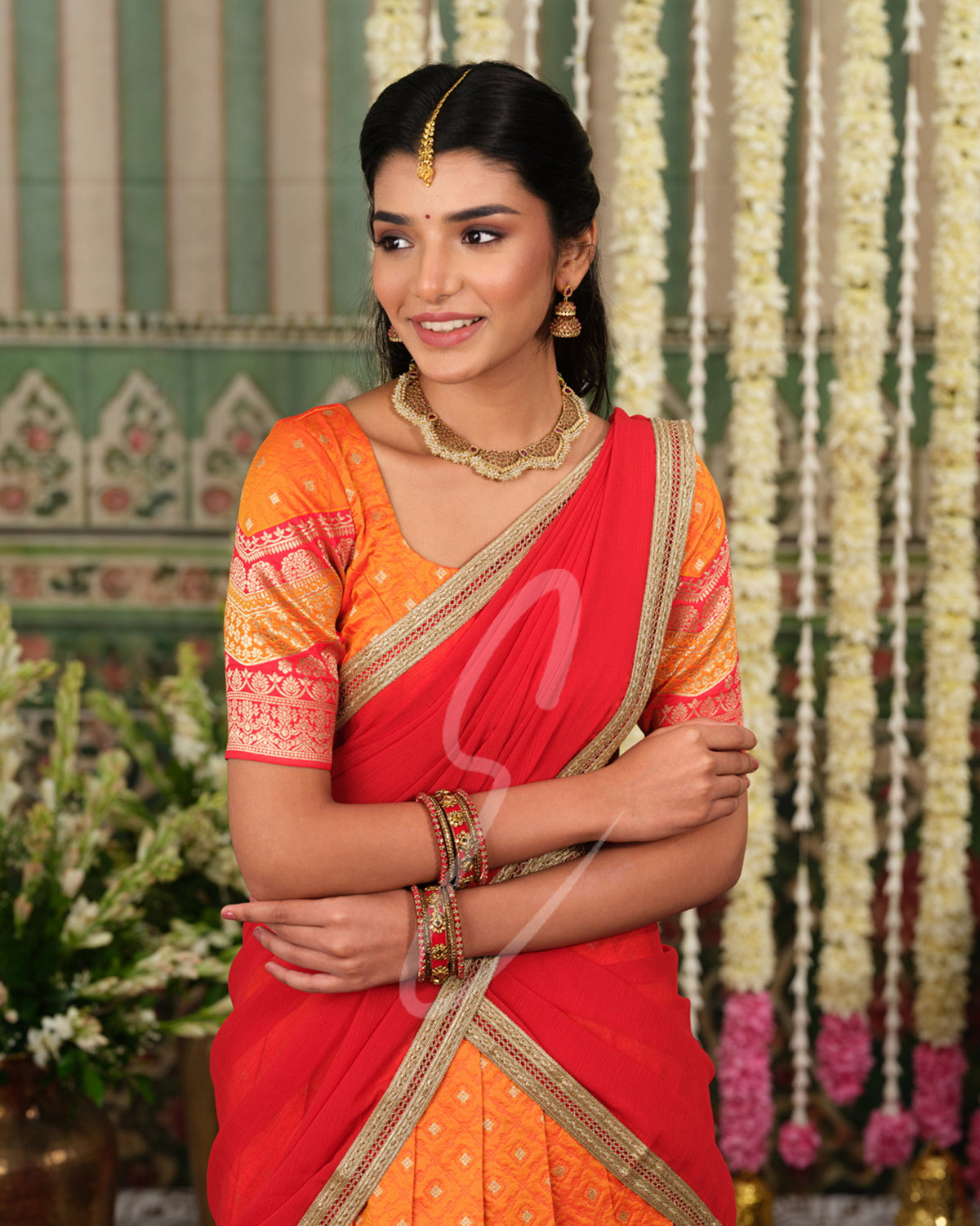 Vibrant orange Banarasi silk half saree with rich woven detailing