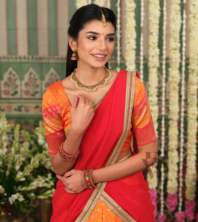vibrant orange Banarasi silk half saree with rich woven detailing