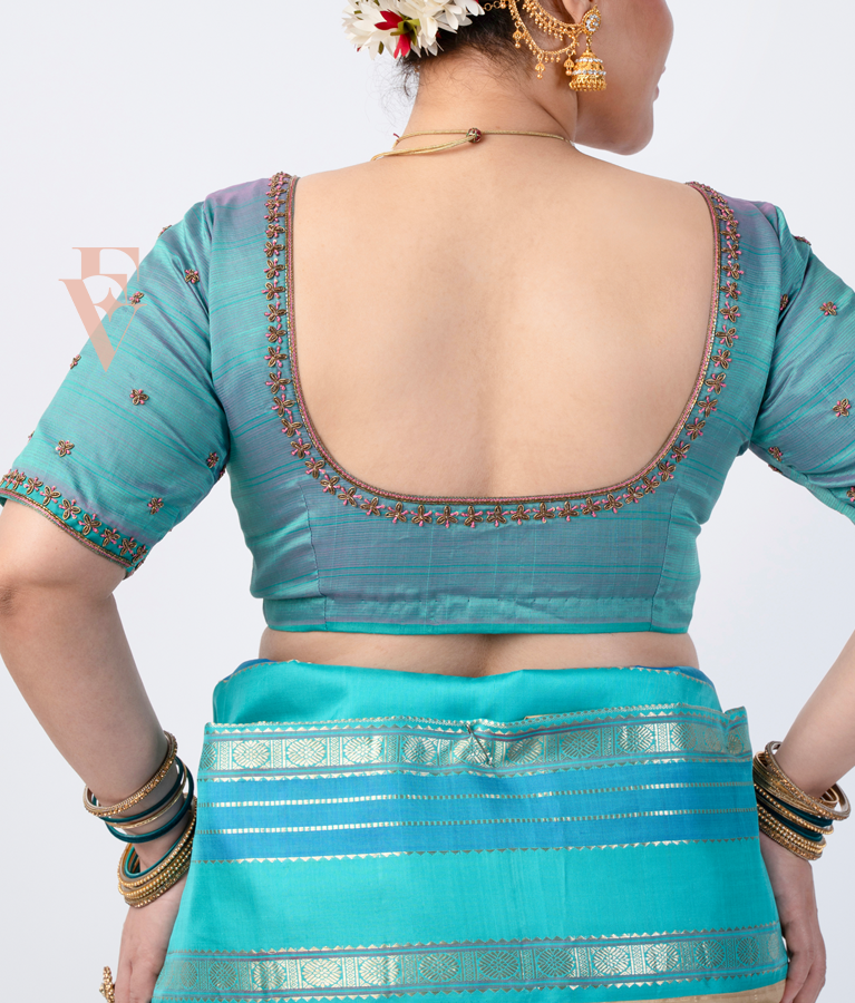 teal silk blouse designed in a princess-cut style