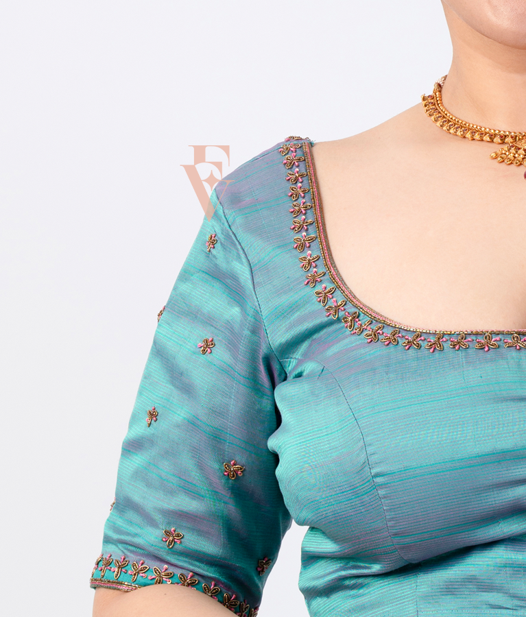 teal silk blouse designed in a princess-cut style