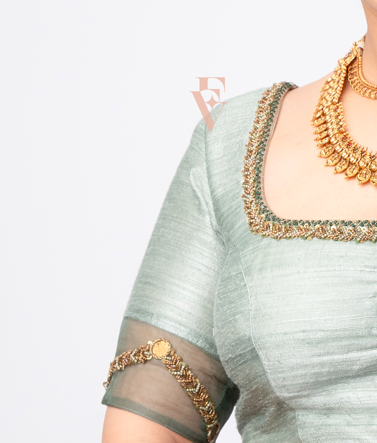 A light green raw silk blouse