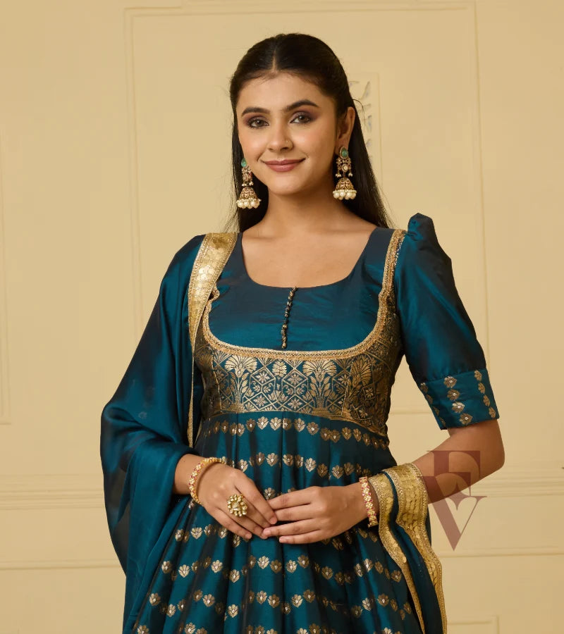 A rich peacock blue Banarasi silk gown