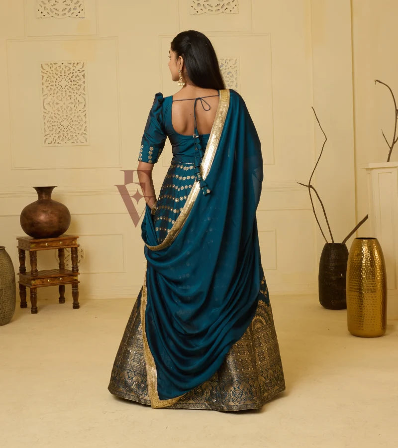 A rich peacock blue Banarasi silk gown
