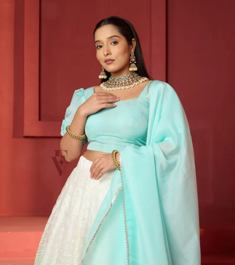 This off-white and turquoise lehenga