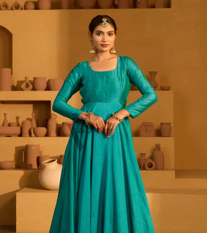 A peacock green flared gown