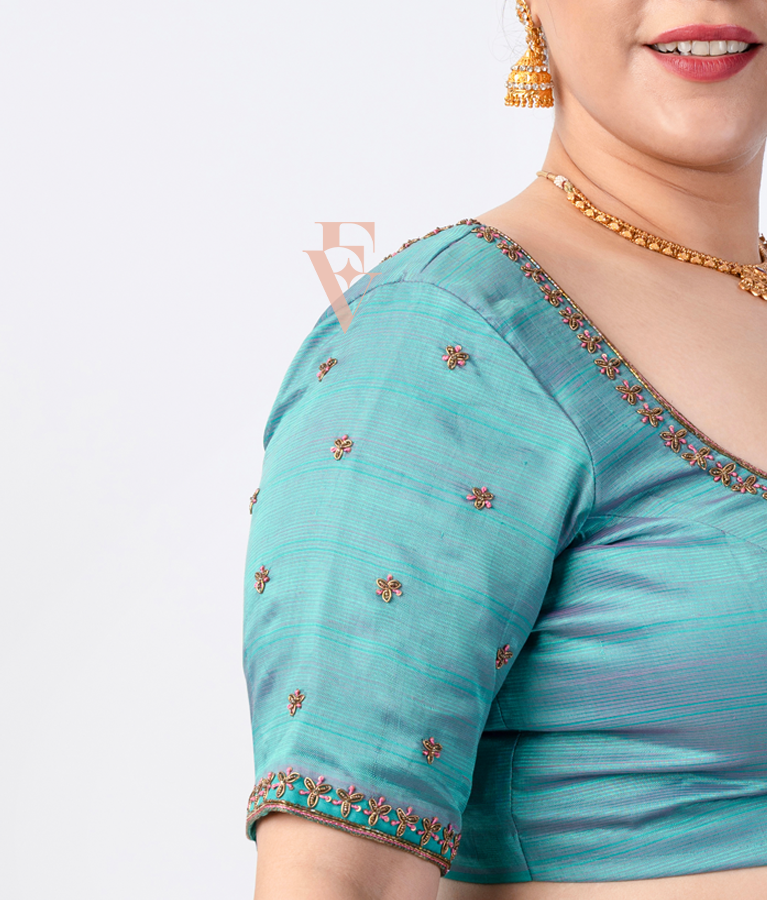 teal silk blouse designed in a princess-cut style