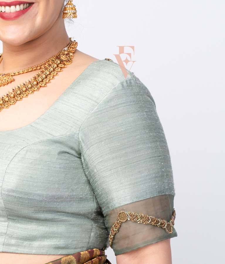 A light green raw silk blouse